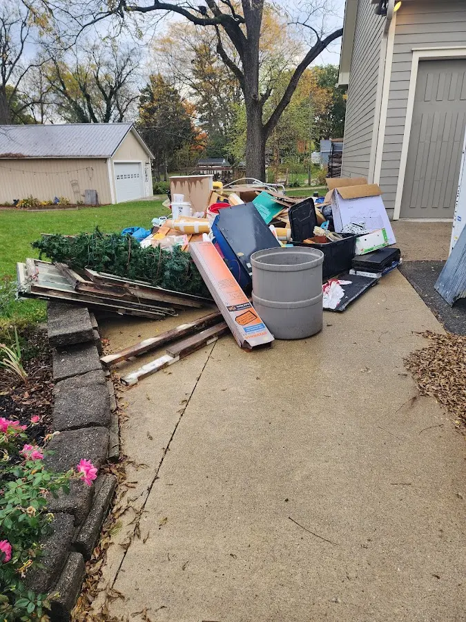 Dumpster being loaded with debris for Estate Cleanout Dumpster Rental in Show Low